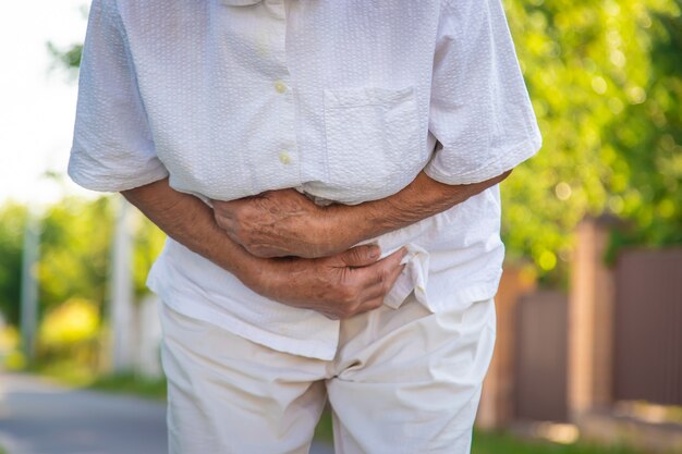 Premium Photo | The old woman grandmother has a stomach ache. selective ...