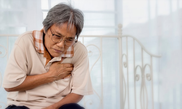 Premium Photo | Old woman with chest pain suffering from heart attack ...