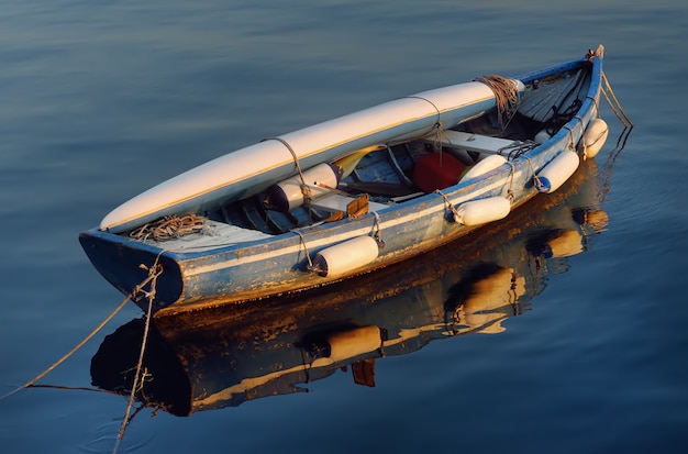Premium Photo | An old wooden boat with a kayak lying on it on the ...