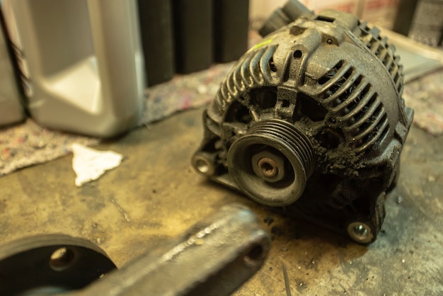 Premium Photo | Old worn alternator of the car to be replaced