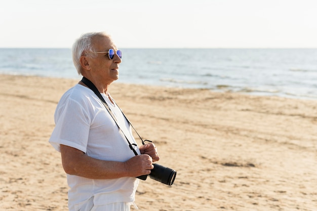 Free Photo Older Man At The Beach With Camera 