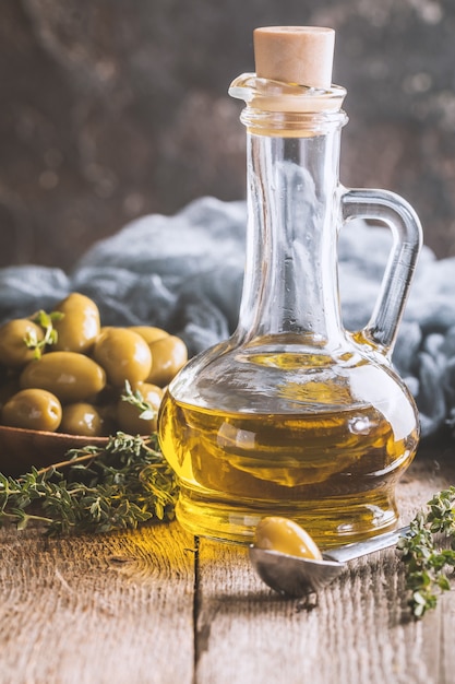 Premium Photo | Olive oil and bowl of olives