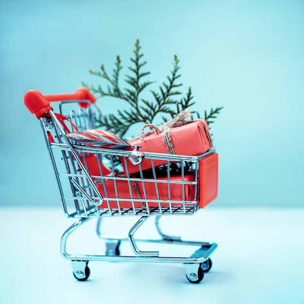 Online shopping concept - trolley full of gifts. black friday and cyber monday Premium Photo