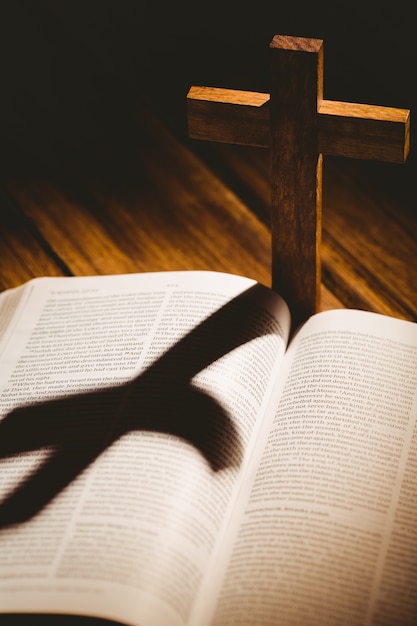 Premium Photo | Open bible with crucifix icon behind