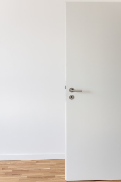 Premium Photo Open White Door With A Gray Chrome Handle And Keyhole Against A White Wall In The Room