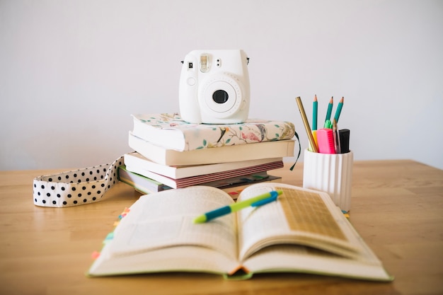 free-photo-opened-notebook-near-small-camera