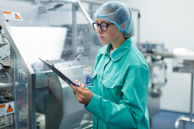 The operator controls the machine in the factory work Premium Photo