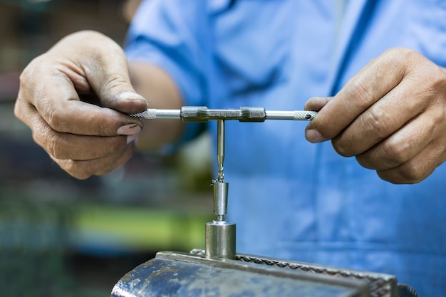 Premium Photo | Operator tapping mold parts by hand