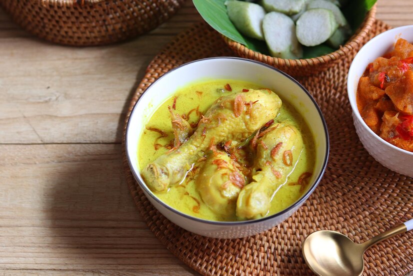 Premium Photo Opor Ayam Chicken Cooked In Coconut Milk Served With