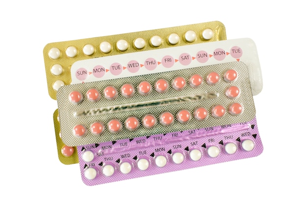 Premium Photo | Oral contraceptive pill strips on white background.