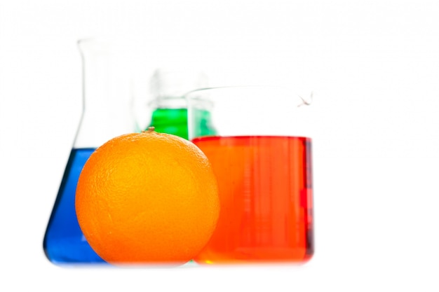 Premium Photo | Orange next to beakers