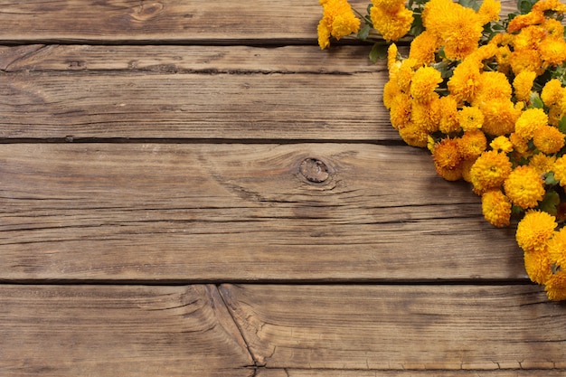 Premium Photo | Orange chrysanthemums on old wooden background