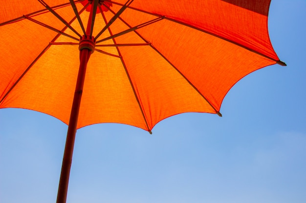 Premium Photo | Orange color beach umbrella made of wooden for ...