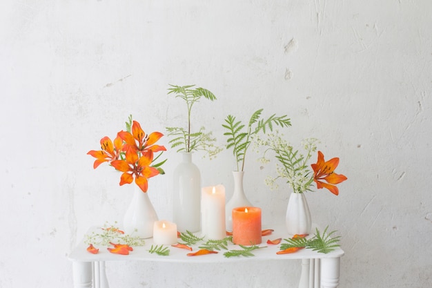 Premium Photo | Orange flowers and candles on white background
