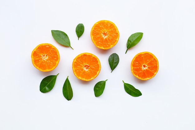 Orange fruits with leaves on white background. Premium Photo