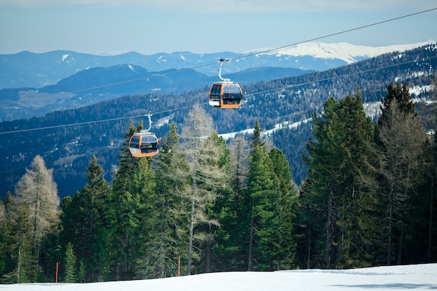 Orange Gondola Cabins Of Cableway Lift On Winter Snowy Mountains