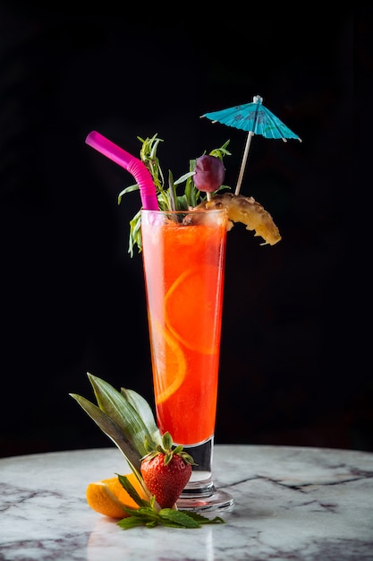 Orange juice cocktail with colorful accesorizes. Free Photo