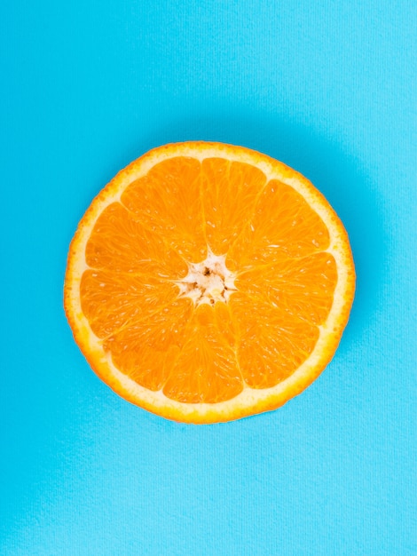 Premium Photo | Orange slice on a blue background