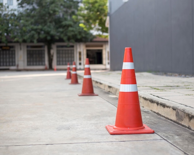 Premium Photo | Orange traffic cones on cement road surface