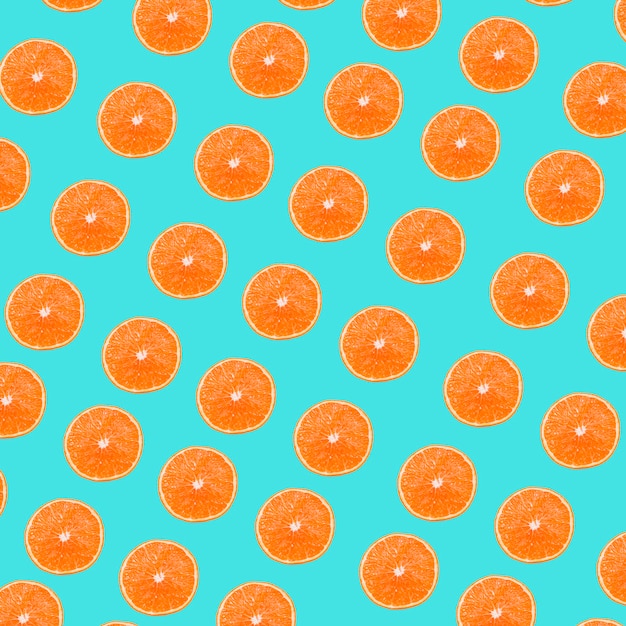 An oranges slices pattern on turquoise background Free Photo