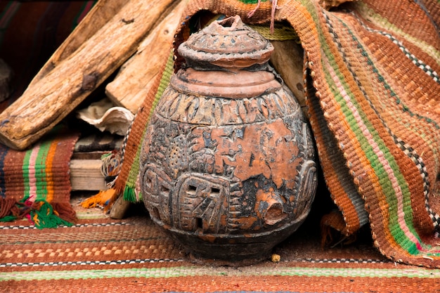  Oriental ceramic jug with ornament on the market square stands on woven ethnic brown carpets