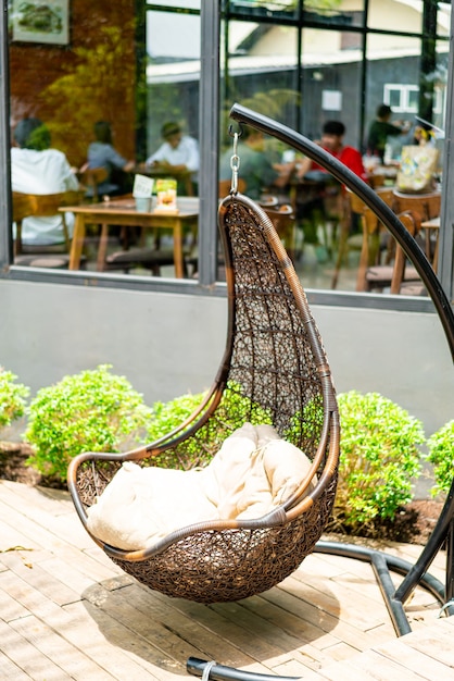 Premium Photo | Outdoor patio with wicker swing chair