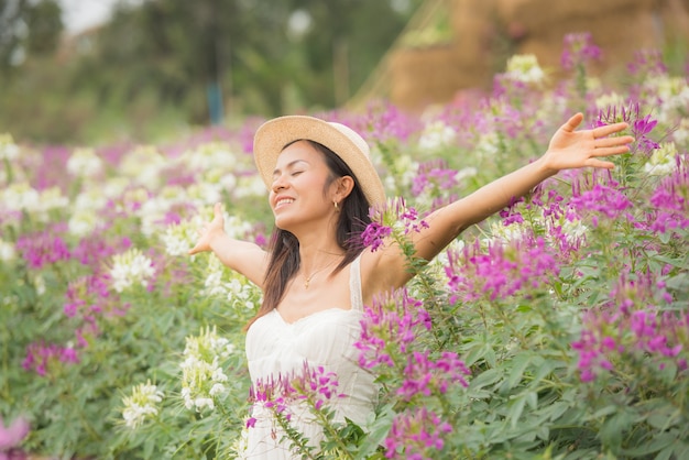 Outdoor portrait of a beautiful middle aged asia woman. attractive girl in a field with flowers Free Photo