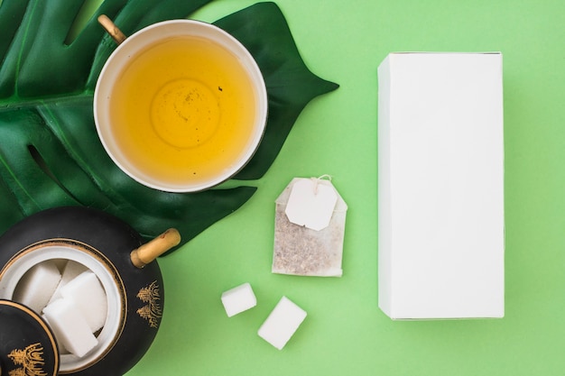 Download Premium Photo Two Tea Bags On The Side Of White Box Over The Green Background PSD Mockup Templates