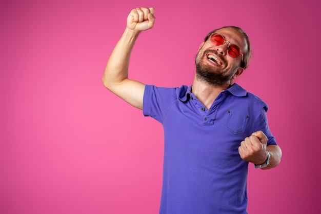 Premium Photo Overjoyed Funny Bearded Man In Glasses Celebrating Success