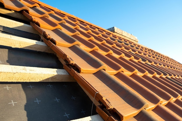 Premium Photo | Overlapping rows of yellow ceramic roofing tiles ...