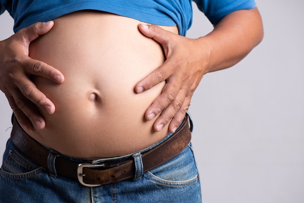 Premium Photo Overweight Or Fat Adult Man Hand Holding Belly Stomach In Very Tight Jeans