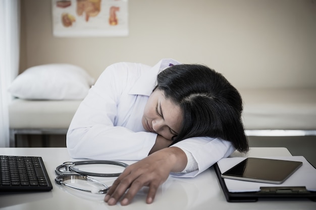 Premium Photo | Overworked medical staff sleep on her workplace.