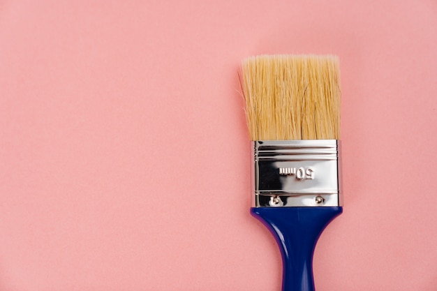 Premium Photo | Paint brush on a pink background