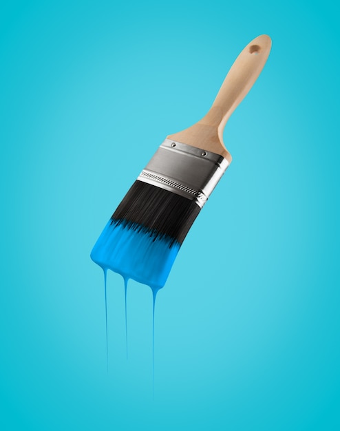 Premium Photo | Paintbrush loaded with blue sky color dripping off the ...