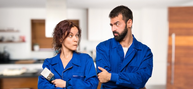 Painters having doubts and with confuse face expression while bites lip in house Premium Photo