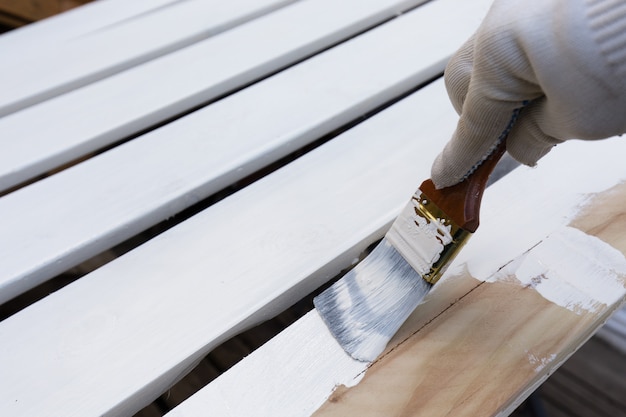 Premium Photo | Painting timber boards with the white paint