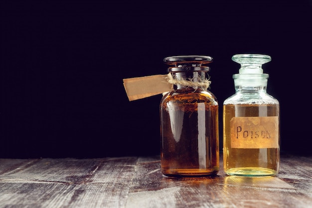 Premium Photo | Pair of apothecary bottles with potion of poison or ...