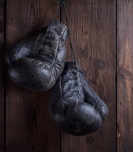 Premium Photo | Pair of very old shabby black leather boxing gloves ...