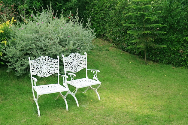 Premium Photo Pair Of Vintage Style White Wrought Iron Chairs In The Green Garden