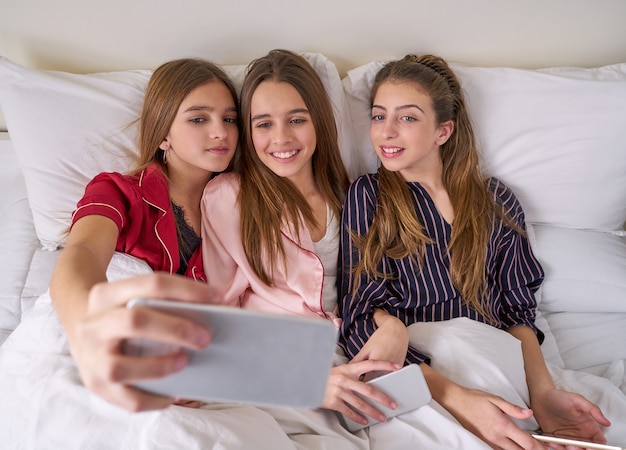 Premium Photo | Pajama party best friend girls selfie at bed