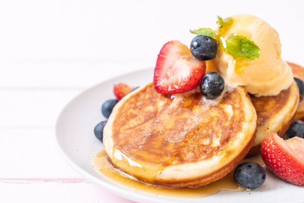 Premium Photo | Pancake with blueberries, strawberries, honey and ...