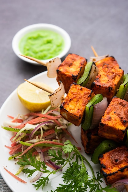 Premium Photo Paneer Tikka Is An Indian Dish Made From Chunks Of