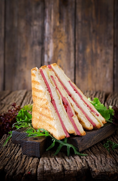 Premium Photo | Panini with ham and cheese on wooden table