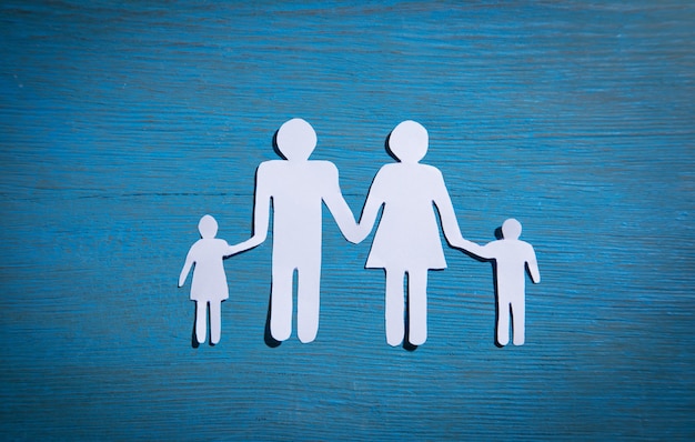 Premium Photo | Paper cut family on blue background.