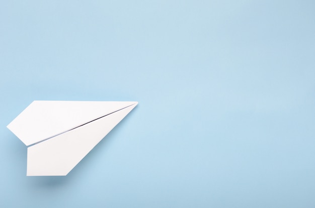 Premium Photo | Paper plane on a blue background.