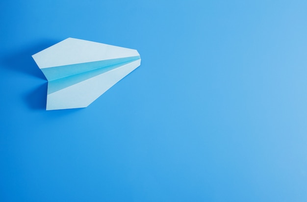 Premium Photo | Paper plane on blue color background