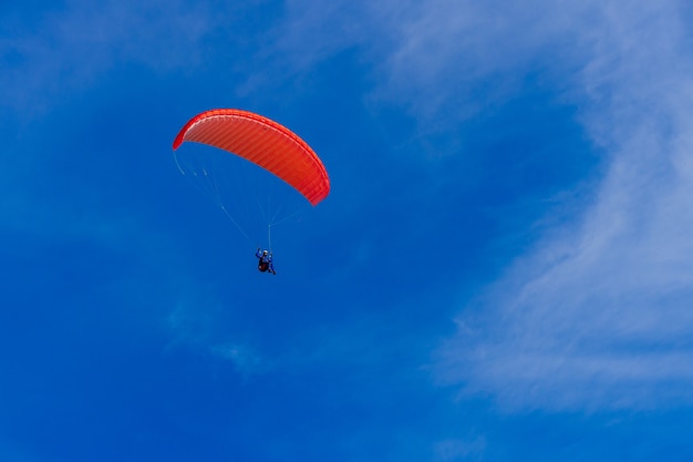 Premium Photo | Paragliding in blue sky. parachute with paraglider is ...