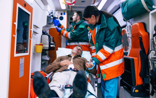 Premium Photo | Paramedics are working with a senior man patient while ...