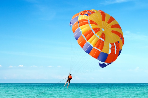 Premium Photo | Parasailing on tropical beach in summer.