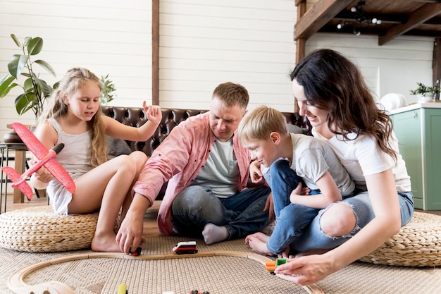 Premium Photo | Parents playing with kids in living room
